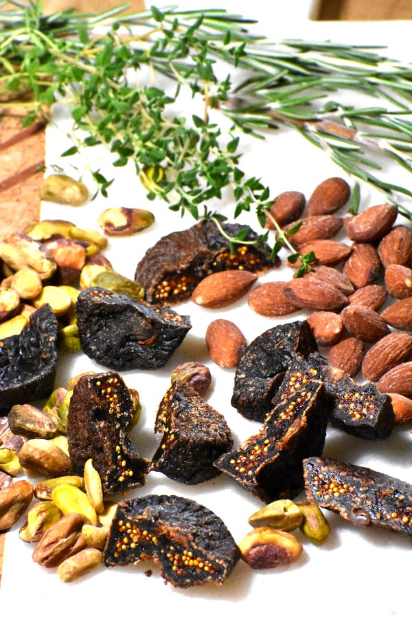 chopped nuts and figs on a nice cutting board