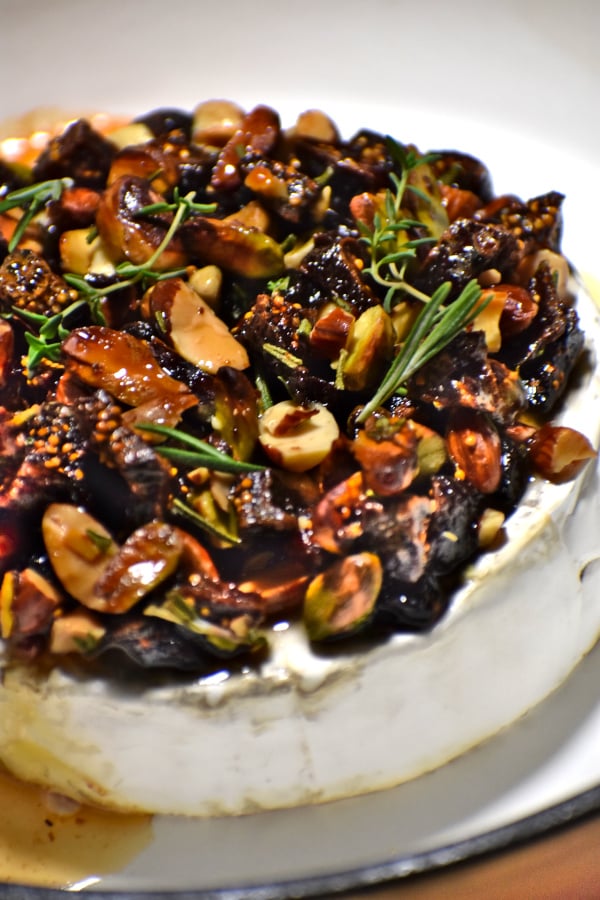 a nice round of brie topped with nuts and stuff