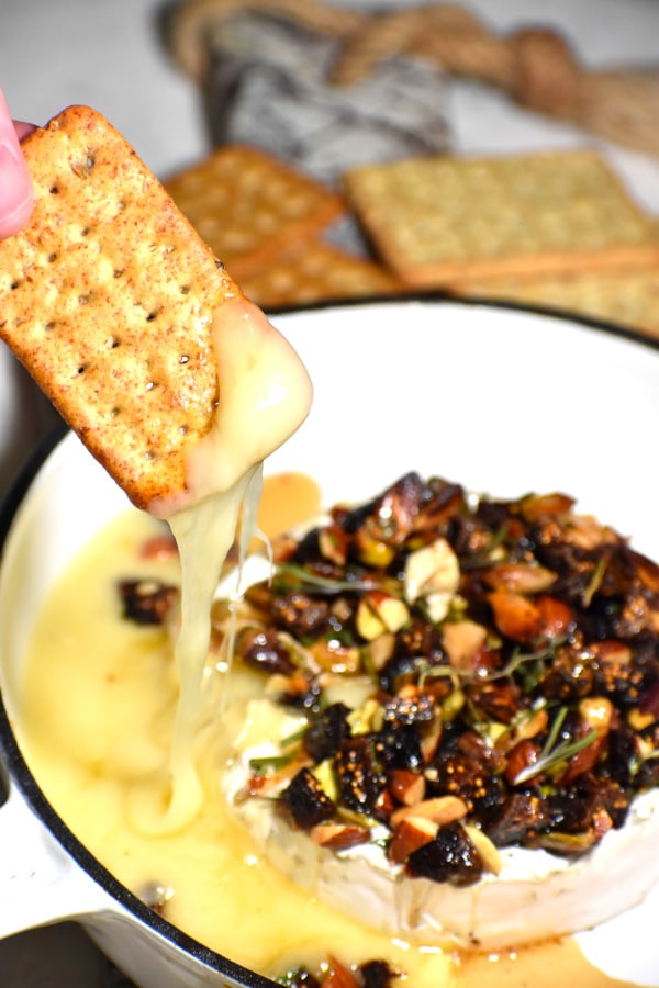 a cracker loaded with melted brie