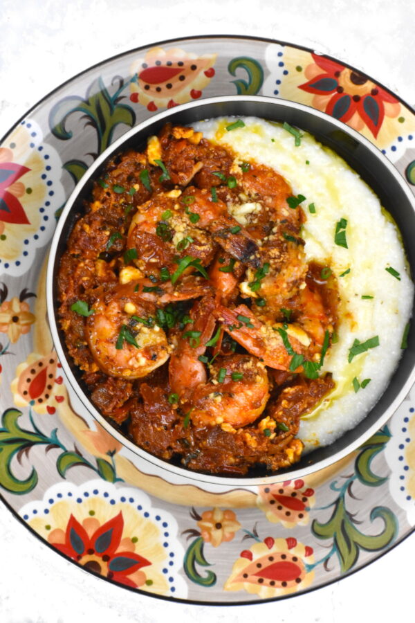 Bowl of Greek shrimp and grits atop the Gypsy Plate.