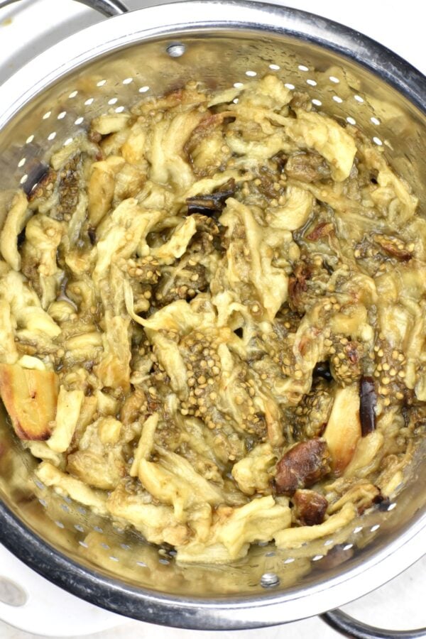 用漏勺沥干茄子